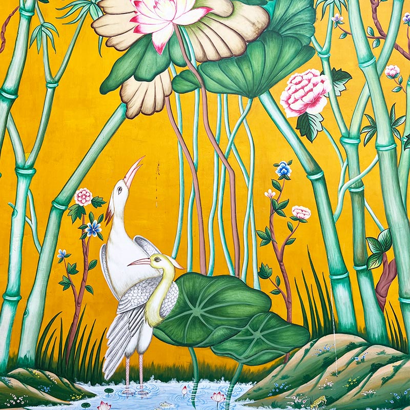 Paiting of two cranes and lotus flowers in bright yellow, green and turquoise colours.