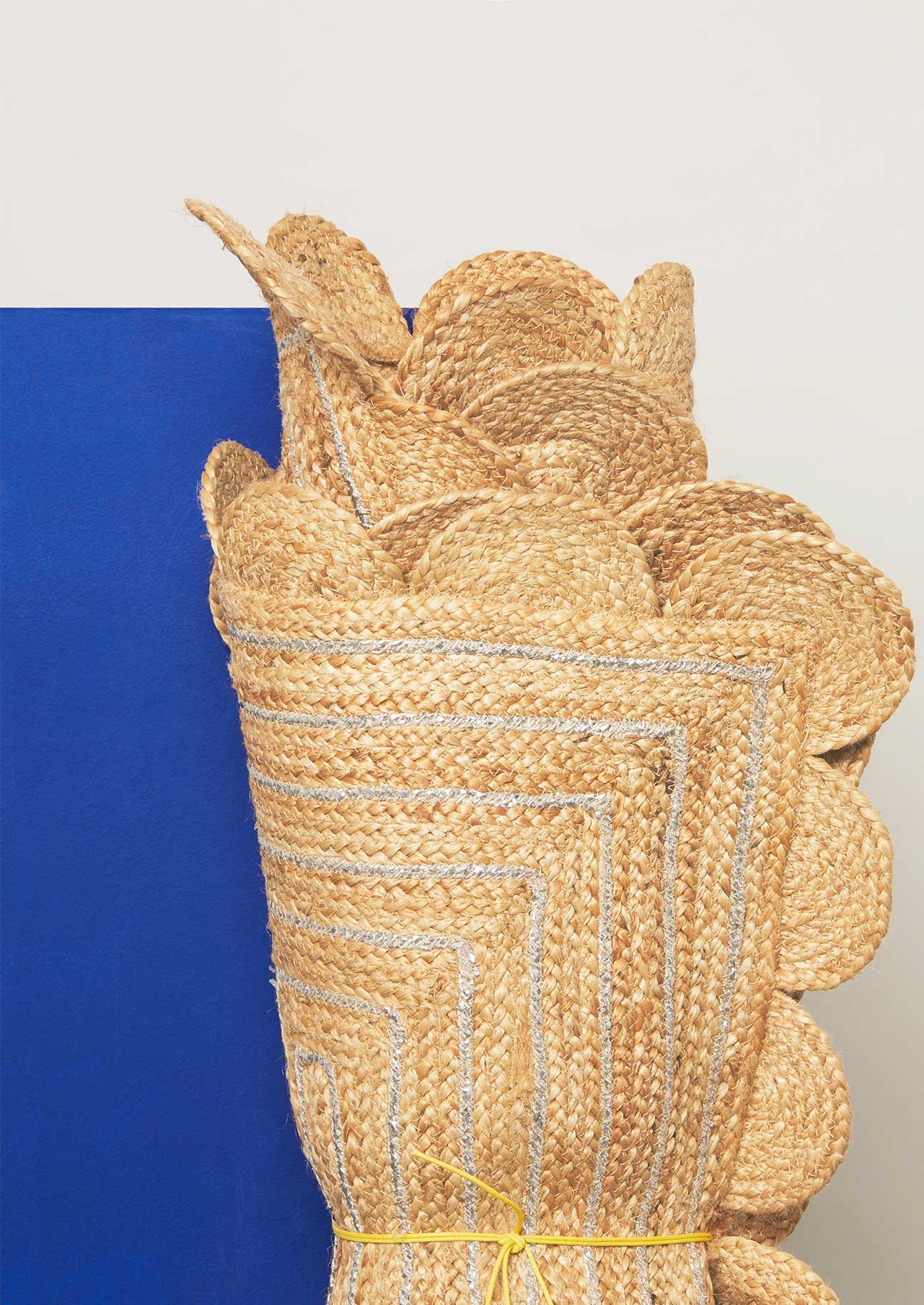 Collection of scalloped edge braided jute rugs with silver detail