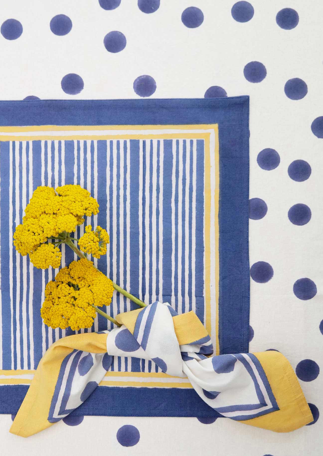 Block printed navy stripe placemat over navy spot tablecloth and matching dot napkin.