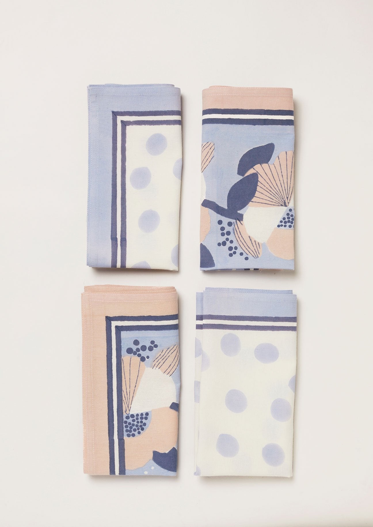 Pale blue, pink, navy and white set of 4 napkins featuring a block printed spot and a large floral design.