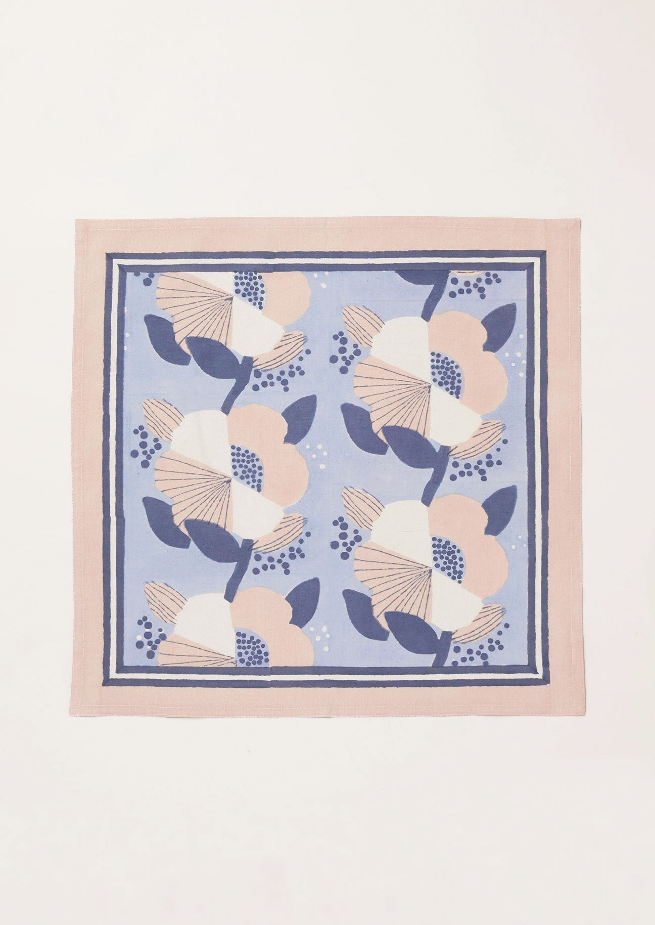 Single pale blue cotton napkin with a large scale navy, pink and white block printed floral design.