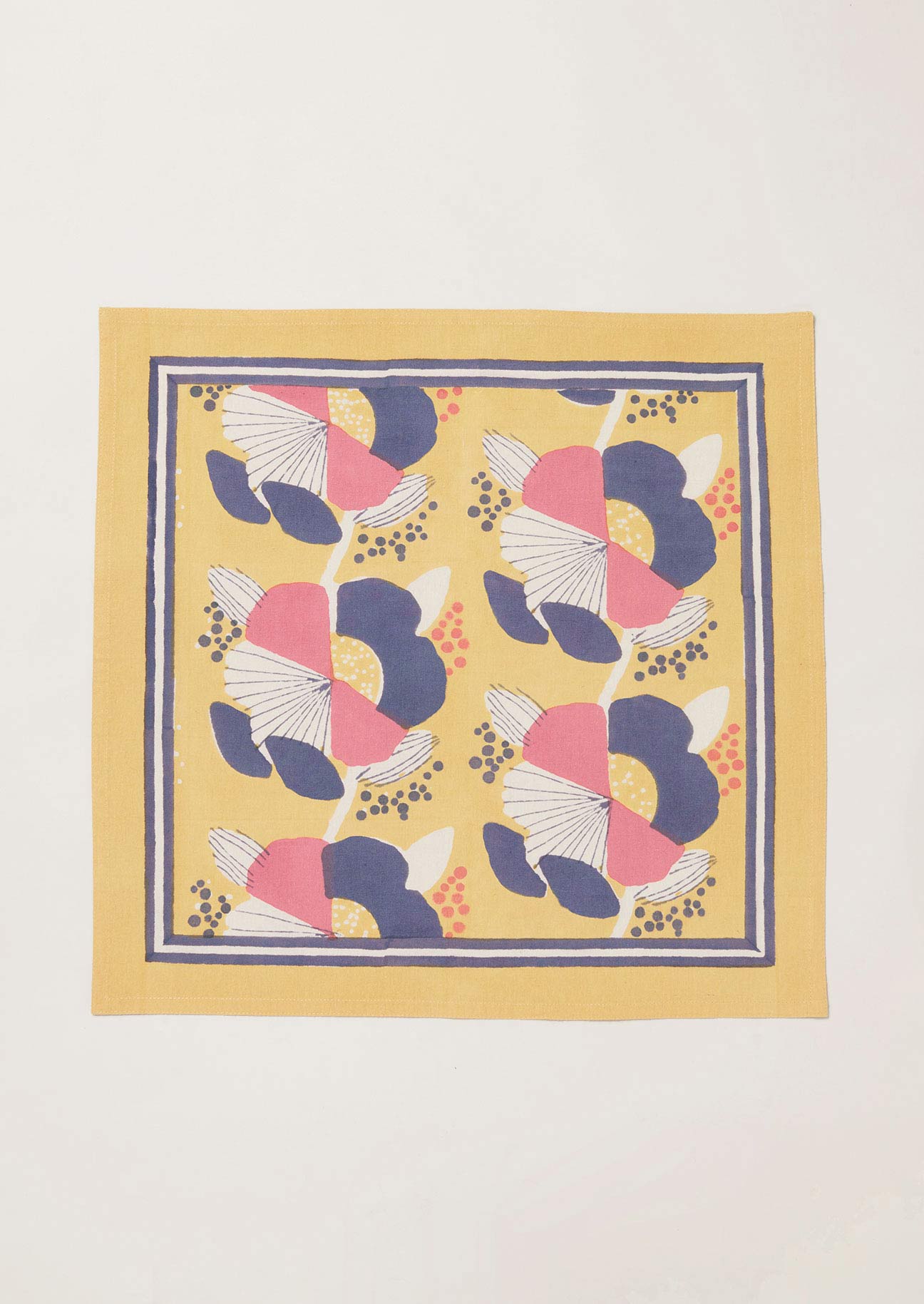 Single yellow block printed napkin with pink and navy flowers and double stripe border design.