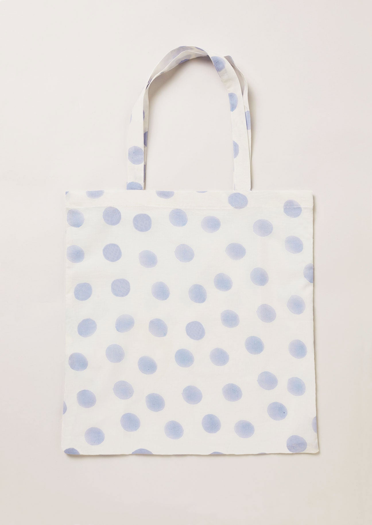 Block printed cotton tote bag in blue dot and white ground.