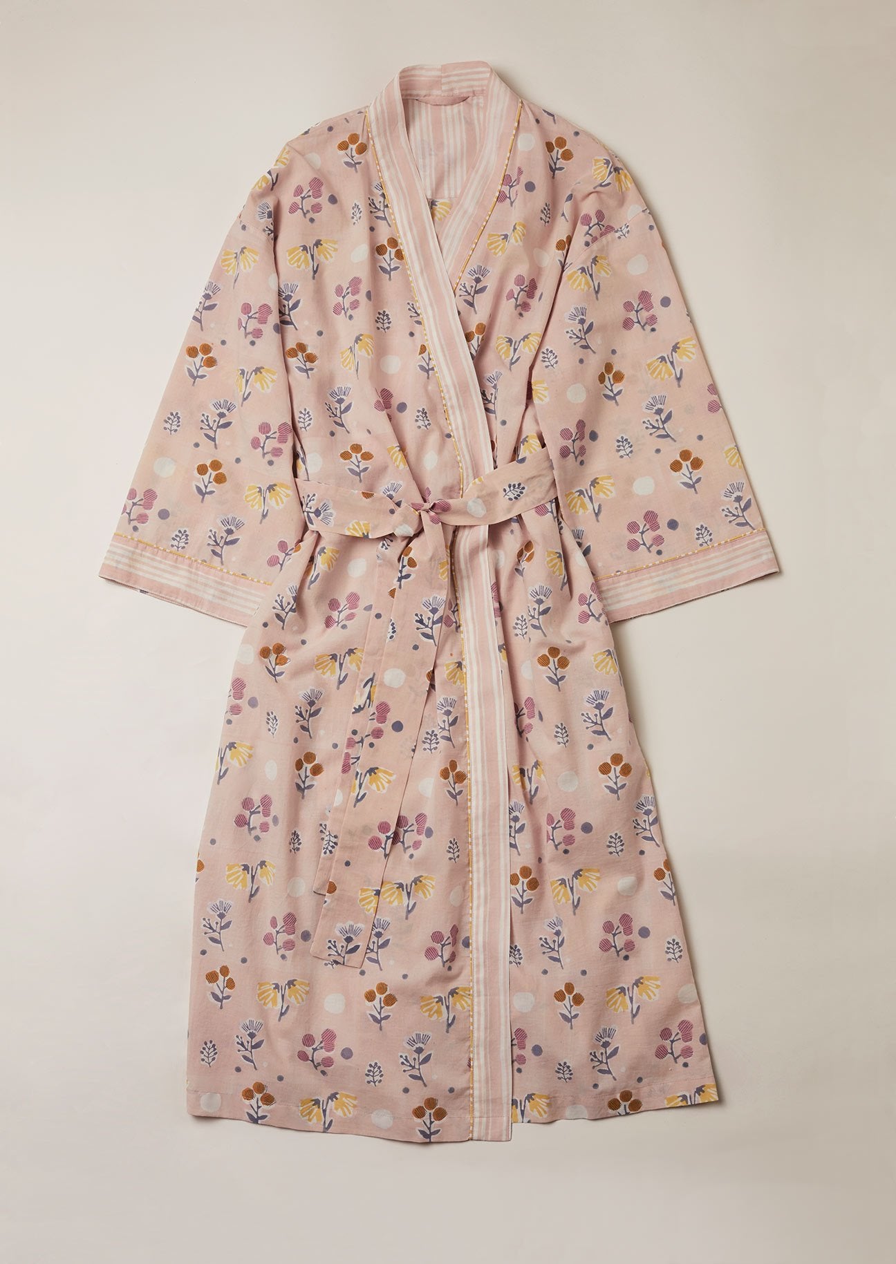Dusty pink cotton kimono dressing gown block printed with mutli coloured flowers and a contrast pink stripe border.