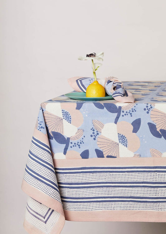 Table setting with matching block printed blue tablecloth and napkin.