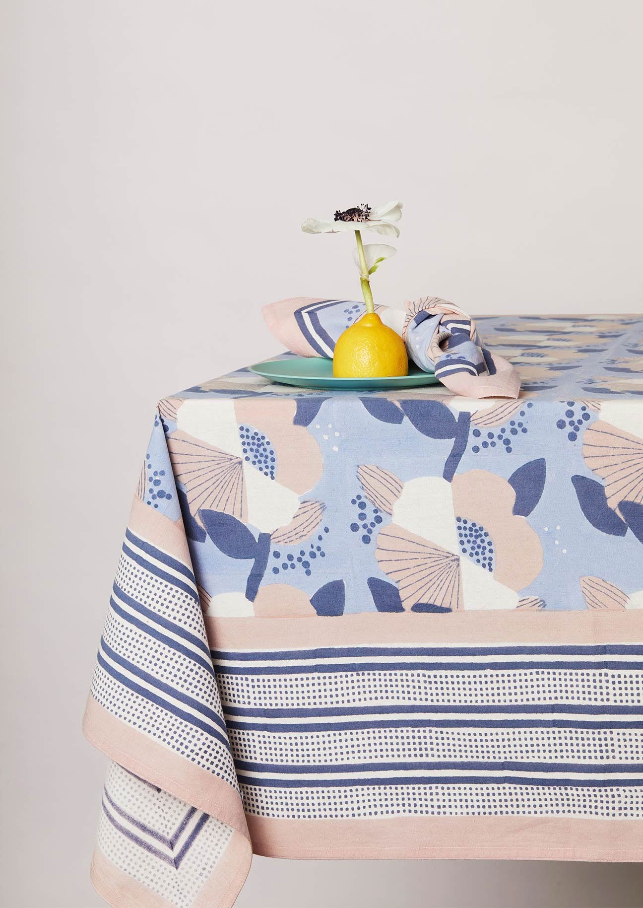 Table setting with matching block printed blue tablecloth and napkin.