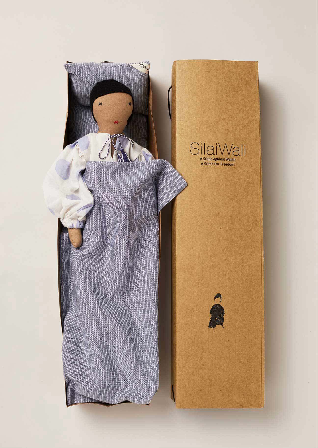 Upcycled rag doll with blue and white printed dress, made by artisans at FairTrade studio Silaiwali