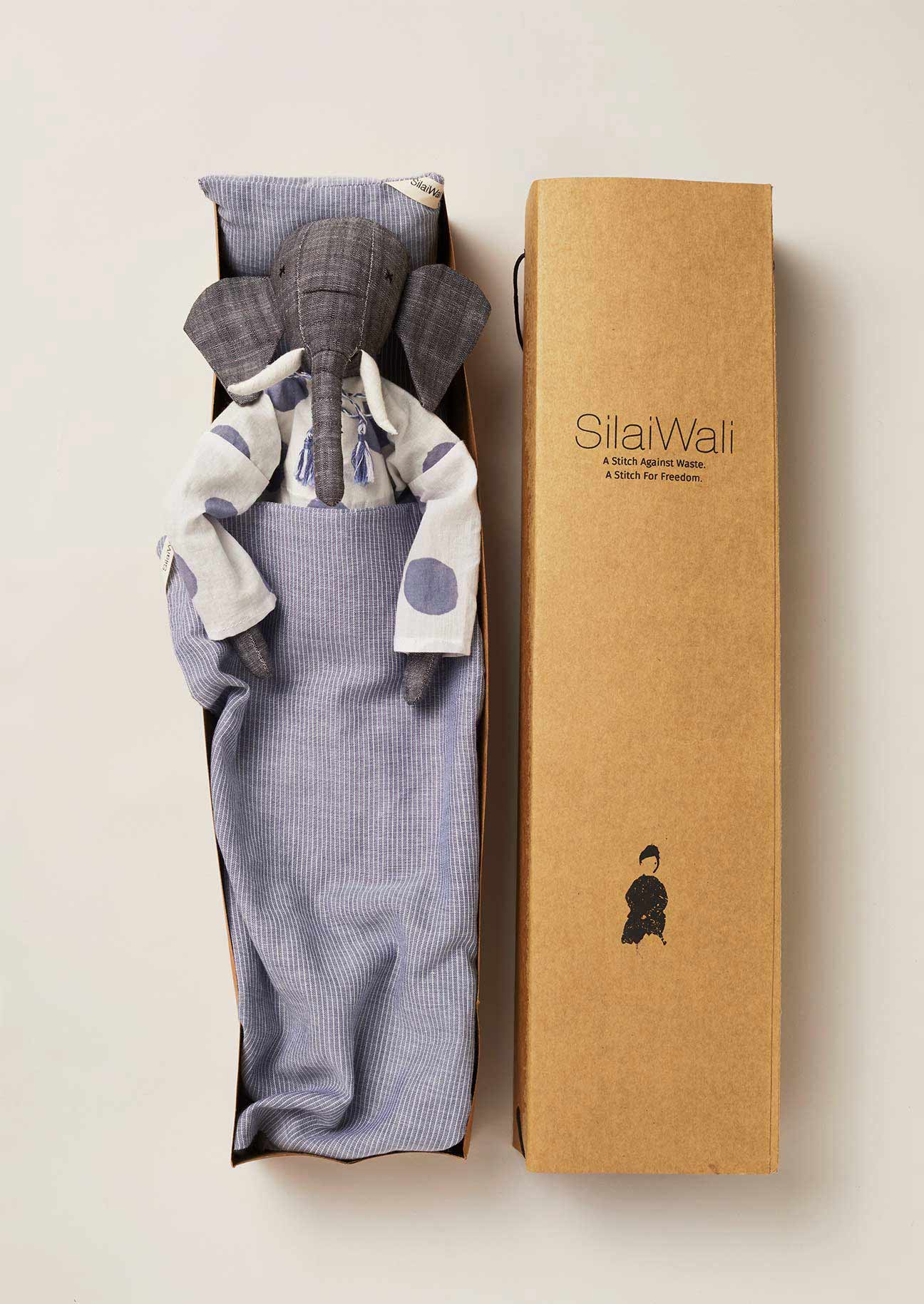 Upcycled elephant rag doll in recycled cardboard box with matching bedlinen.