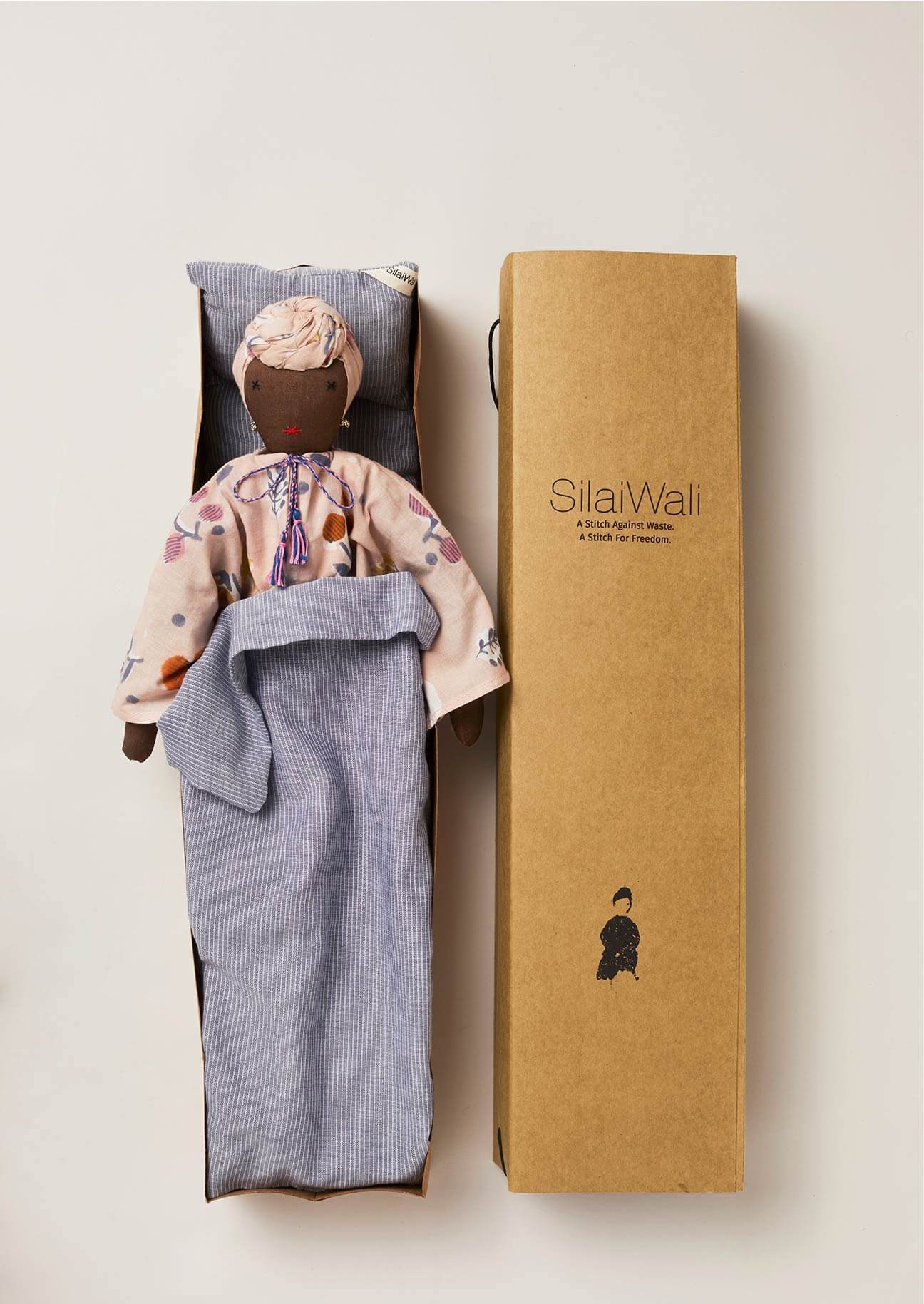 Upcycled doll with bedlinen inside SilaiWali cardboard gift box.